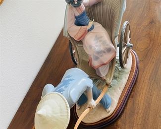 38_____$250 	
Lladro 1383 China lady in rikshaw 15x13x9 - missing finger -AS is 