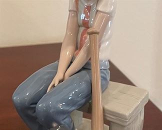 _____$36 	
Lladro the baseball boy #5291Leager on the Bench bow 	
