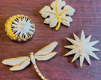 _____$46 	
Swarovski set of 4 brooches 	