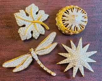 _____$46 	
Swarovski set of 4 brooches 	