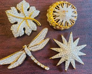 _____$46 	
Swarovski set of 4 brooches 	