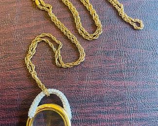 _____$55 	
Swaroski vintage necklace gold plated chain with loupe pendant 	