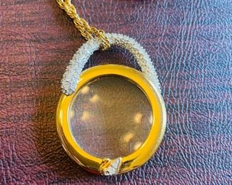_____$55 	
Swaroski vintage necklace gold plated chain with loupe pendant 	