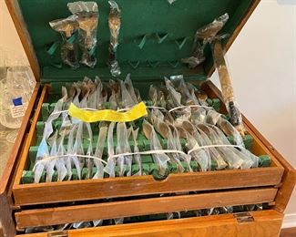 $150 - Brass and black handles Thai flatware set in fitted chest - service for 12