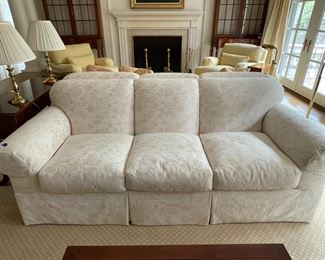 Baker rolled arm sofa, tight back with three loose seat cushions and skirt.  Upholstered in Luciano Marcato fabric.   Two identical sofas available.