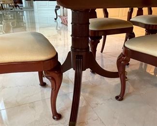 Baker Regency mahogany 2- pedestal dining table with broad satinwood crossbanded and ebonized borders.  Sits on 3 carved and reeded leg terminating in brass toes and casters.  78"W x 48"D x 29"H (plus three 19" fillers (extensions)