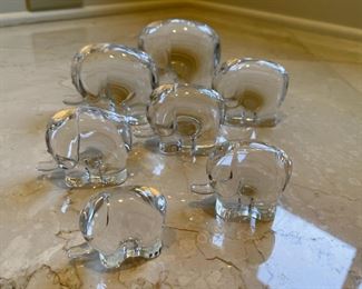 Crate and Barrel set of seven glass Elephants in ascending size order.