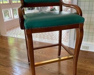 Trouvailles; Restoration "B" Bar Stool.  Finished with antique brass nails, brass footrail and upholstered in a Paul Brayton Spruce, nylon, fabric.  Four chairs available.