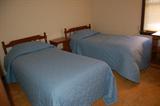 Twin beds, maple headboards.