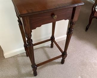 Marquetry inlaid walnut table with reeded legs. 