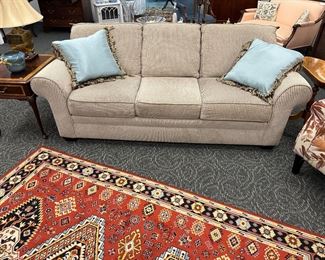 Modern grayish white sofa, Mahogany end tables by Thomasville, mid century southwest area rug (two matching throw rugs)