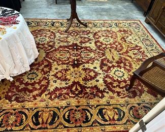 Large wall area, rug in jewel tone, colors gold navy and red