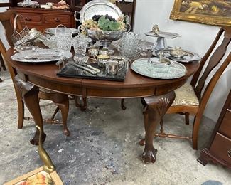 Antique, solid, mahogany table and chairs with ball and claw feet in a Cabrio leg