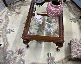 Round area rug, Beveled glass coffee table with Cabrio legs