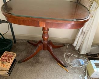 #56	oval wood end table on pedestal with protective glass 26x16x22	 $45.00 			
