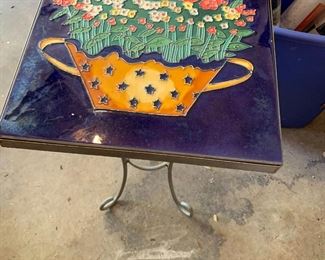 #148	tile top metal base with flower design 12x20	 $20.00 			
