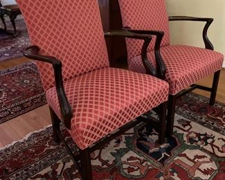 Mahogany Chippendale upholstered armchairs in a red diamond design.
