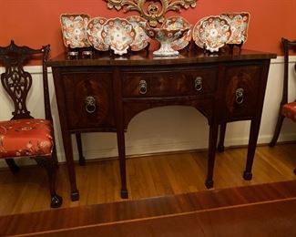 English Mahogany Bow- front Sideboard with Three  Drawers with Brass Lion Head Pulls. Circa 1820.