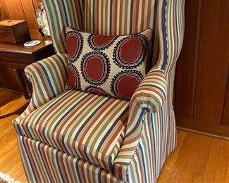 20th century wing chair with striped upholstery.
