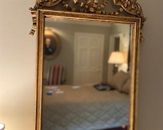 Gilt Louis XVI style Beaux Art mirror with bow knot crest. Late 19th century.
48”x24”