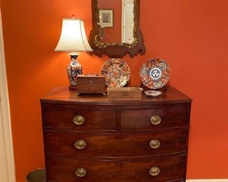 English mahogany Bow-front five drawer chest with oval brass pulls on splay feet.
Circa 1850.