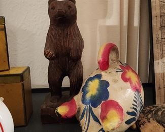 Carved bear and Mexican pottery pig bank