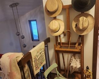 Early  hall tree, hats, child's chair in green, canes and umbrella, cross-stitch,  woven Native American design wool rug