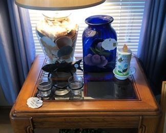 Lamp table with seashell filled lamp.