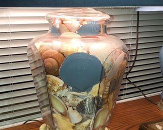 Close up of lamp filled with shells.  There are two.