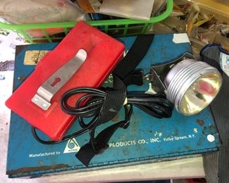 Vintage battery powered head band with light.  Old metal First Aid Kit