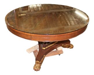 
Lot 510
Baker Regency style 54" diameter banded mahogany center/dining table with custom glass top

