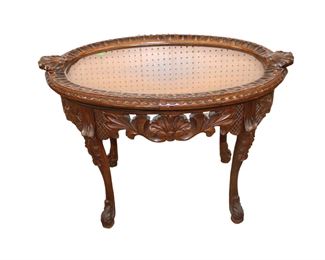 
Lot 564
Antique carved walnut glass top serving table
