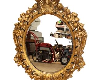 
Lot 617
Heavily carved bevel glass composition decorator mirror
