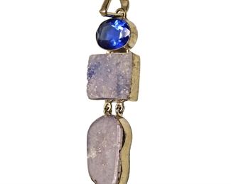 
Lot 702
33.40ct blue solar quartz and sapphire sterling pendant
