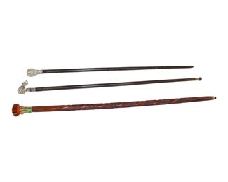 
Lot 711
3 walking sticks (Canes) 1 carved with amber glass handle and more
