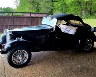 This is a 1951 MG TD.  It has new spoke wheels and includes a new light brown soft top.  Dr. Lawler had planned to paint the car light brown.