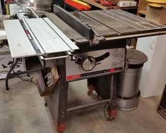 Craftsman 10 inch 'Bench' saw (table saw) with slide accessory.  Next to it is an 80,000 btu propane heater.