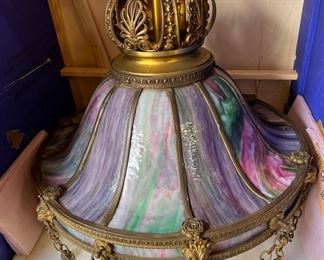 Antique purple, green and pink slag glass chandelier with lion swag details; it’s large and already crated