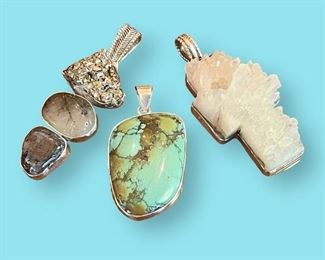 Rebecca Collins pendants on left and right. Center turquoise pendant is signed Native American