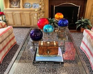 Heavy iron and glass coffee table; antique hand blown glass balls on brass stands; antique English box