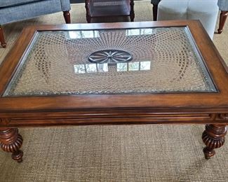 Stylish glass top coffee table with inset woven details