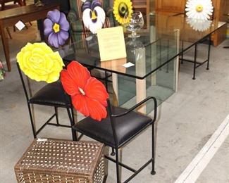 Fun glass top table with metal flower backs.  Great for a covered patio or porch.