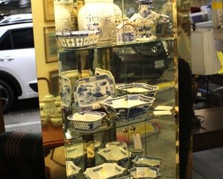 Beautiful corner display cabinet shown with lots of blue and white decorative china.  