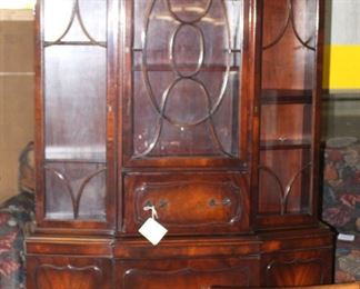 Gorgeous china/display cabinet.  In  front of it is a very unusual dining table made in Ireland.  