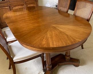 Kindel “Borghese” dining table with three leaves, six chairs, and pads.