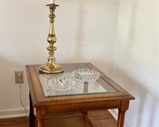Glass top side table with brass lamp