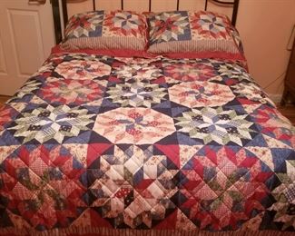 Metal bed with beautiful patchwork quilt