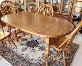 dining table with 4 chairs and shown with 1 leaf inserted. Table pads included. Has matching china cabinet and server