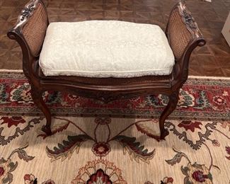 Cane and carved wood bench with custom pillow 