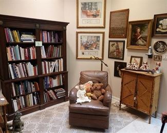 Bookcase with lots of great books, leather rocker, bamboo cabinet